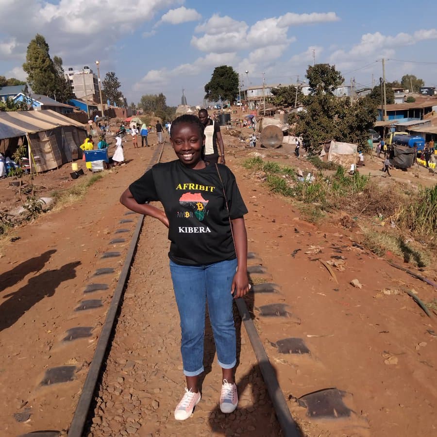 Susan standing in Kibera, ready to guide visitors through the walking experience