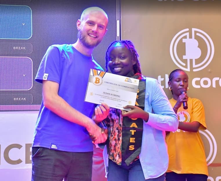 Susan receiving a certificate of completion at a Bitcoin education event